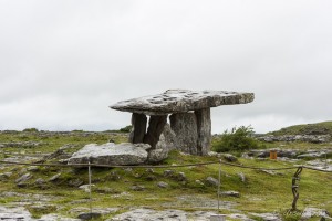 View of Poulnabrone Tomb in Co Clare, Ireland, from the back, under a wet grey sky.