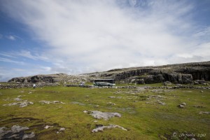 A Barratt Tour bus sits in the distance, on the Black Head Coastal Drive, the Burren, Co Clair, Ireland.