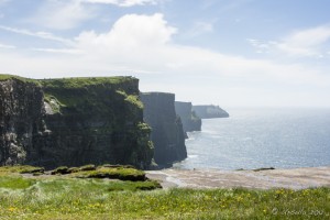 Landscape: view of the Cliffs of Moher under blue sky and white cloud.