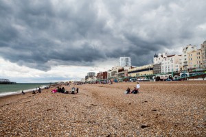 Looming clouds over a stretch of shingle beach, Brighton, UK