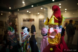 Punch puppet in a glass case, with a clown, policeman and other puppets in the background, Brighton Fishing Museum, UK