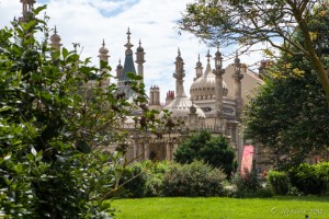 Roofline of the Royal Pavilion behind green trees, Brighton, UK