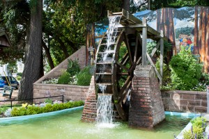 A waterwheel with a painted mural backdrop, Chemaiinus BC