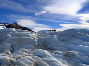 People silhouetted against a blue sky, Perito Moreno, Patagonia