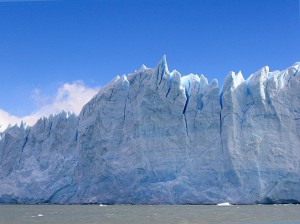 Front wall of glacial ice against a blue sky. Perito Moreno
