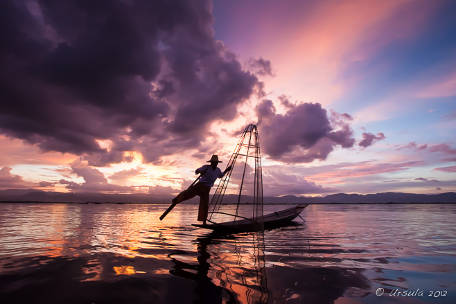 Sunset silhouette of a leg-rowing fisherman, Inle Lake Myanmar