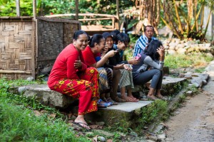 Locals sitting at the side of the road, Bukit Lawang.