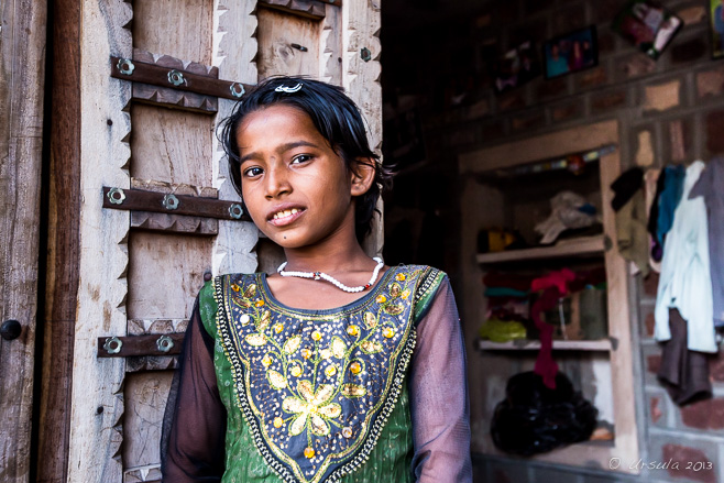 Indian pre-teen Girl at the Doorway of her untouchable home, Thar Desert, Rajasthan, India