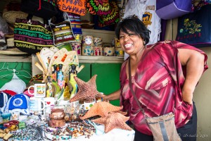 Bahamian Saleslady with a table of starfish and shells, Nassau the Bahamas