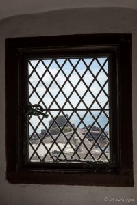 View of St Helier's Hermitage from inside a Grated Elizabeth Castle Window