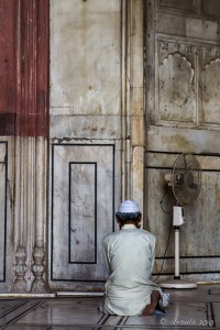 Seated man facing a mosque wall, Jama Masjid, Old Delhi