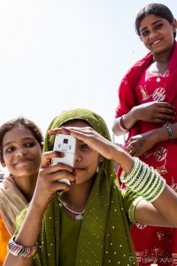 young Indian women taking a picture around the Reflecting Pond, Jama Masjid, Old Delhi