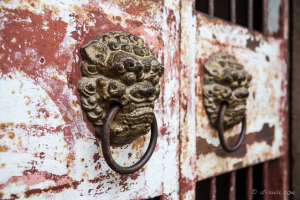 Detail: Ornate brass door handles outside the base of Zhenguo Pagoda,