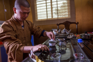 A Chinese Buddhist monk making tea, Jinjian, China.