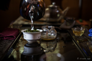Water being oared onto fresh tea leaves, Jinjiang China