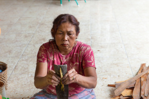 A Sumatran woman sitting on the floor with Cinnamon bark, North Sumatra