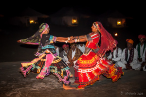 Two Kalbelia Dancers in ornate gypsy dresses and musicians, Manvar Desert Camp, Dechu, India