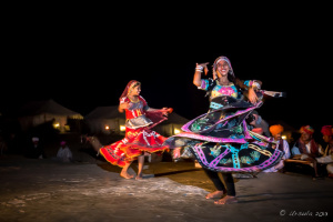 Two Kalbelia Dancers in ornate gypsy dresses and musicians, Manvar Desert Camp, Dechu, India