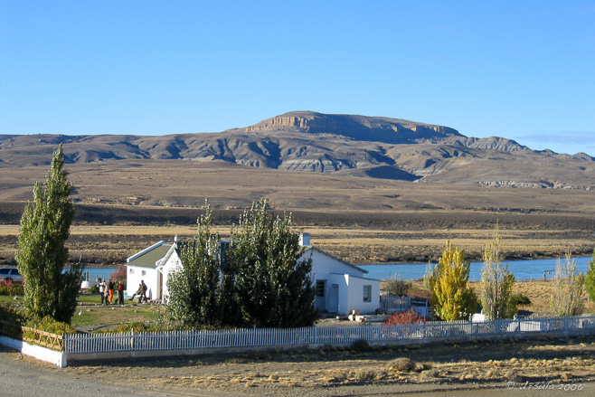 Landscape: Patagonian badlands with a homestead in the foreground.