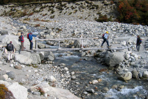 Hikers on the Creek crossing on the way to Poincenot base camp, Patagonia Argentina