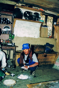 Nepalese man forming Cornbread in a kitchen, the Annapurnas, Nepal