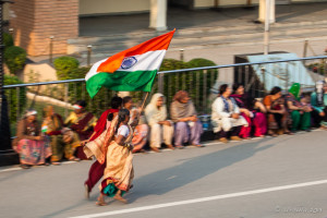 Women running with an Indian flag, Wagah Border, Amritsar Punjab India