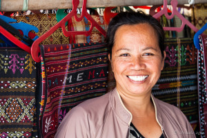 Toba Batak woman with fabrics for sale, Samosir Island, North Sumatra