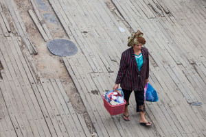 Batak woman carrying baskets of goods on the Ferry Dock, Samosir Island, North Sumatra