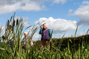 People behind bullrushes, Tiverton Canal, Devon UK