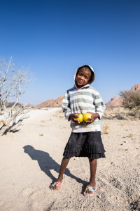Young Damara Girl with Apples, Spitzkoppe, Namibia