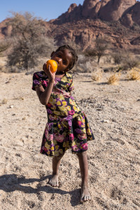 Young Damara Girl with an Orange, Spitzkoppe, Namibia