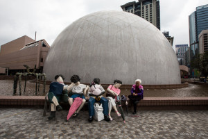 Ju Ming's sculpture of people sitting on a low wall, Hong Kong Museum of Art TST