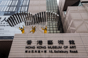 Ju Ming sculptured figures Parachuting over the Hong Kong Museum of Art TST