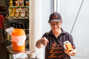 A woman in a cap dishing up cheese, Smelly Cheese Shop, Pokolbin AU