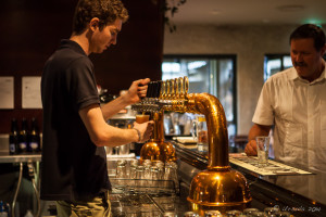 Young man behind a beer tap, Potters Hotel Brewery Resort, Nulkaba AU