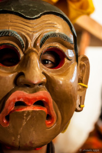 Burmese man in a grimacing cham mask, Wangduephodrang Dzongkhag Dzong, Central Bhutan.