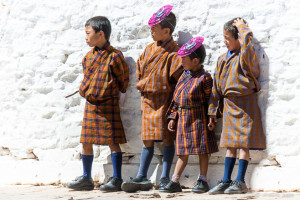 Bhutanese boys in gho and Spidermen masks, , Wangduephodrang Dzongkhag Dzong, Central Bhutan.