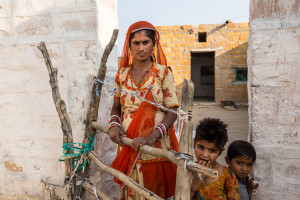 Rajasthani Woman and children at a courtyard gate, Khuri Village