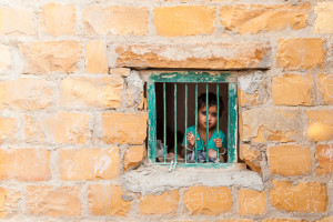 Rajasthani child at a barred Window, Khuri Village