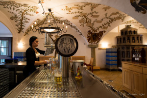 A woman pouring beer inside the Schneider Brewery, Kelheim