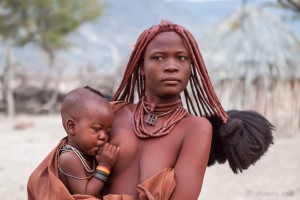A Himba woman with a baby, Otjomazeva Village, Kunene Namibia