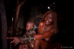 Himba Mother and Child in a dark hut, Otjomazeva Village Namibia