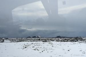 Flat, snowy landscape through a glory bus window, Reykjanes Peninsula Iceland