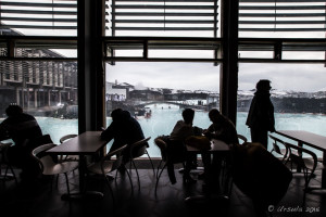 People silhouetted against a view over Blue Lagoon, Blue Café, Iceland