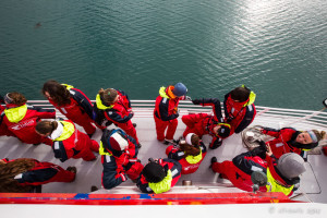 Whale-watchers in red and yellow foul-weather suits, Reykjavík, Iceland