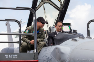 Young RSAF pilot showing his F-16D+ Fighting Falcon to a visitor, Singapore Airshow 2016