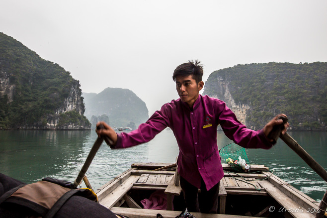 Male rower in a wooden boat, Vung Vieng, Bai Tu Long Bay, Vietnam