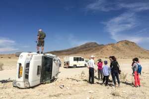 Man standing on a crashed truck, Namibia