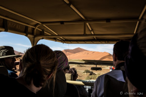 Silhouetted people in a jeep, Namib-Naukluft Park Namibia
