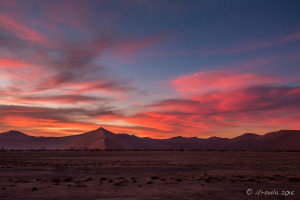 Red clouds over dark dunes at sundown, Namib-Naukluft Park, Namibia